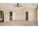 A spacious bedroom with neutral carpet, ceiling fan, and access to an ensuite bathroom at 50 Fieldview Ln, Covington, GA 30016