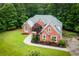 Beautiful landscaped home on a sprawling green lot, with mature trees, and a long driveway at 7406 Cherry Blossom Way, Winston, GA 30187