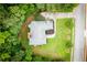 Aerial view of the home showcasing the lush, green lawn and tree coverage at 7406 Cherry Blossom Way, Winston, GA 30187