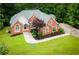 Beautiful landscaped home on a sprawling green lot, with mature trees, and a long driveway at 7406 Cherry Blossom Way, Winston, GA 30187