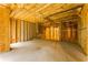 Unfinished basement featuring exposed framing and concrete floor at 7406 Cherry Blossom Way, Winston, GA 30187