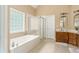 Bright bathroom with a separate tub and shower at 7406 Cherry Blossom Way, Winston, GA 30187