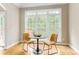 Bright breakfast nook area with hardwood floors and large window overlooking the backyard at 7406 Cherry Blossom Way, Winston, GA 30187