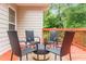 Outdoor deck area with seating provides a relaxing space for entertaining, overlooking a wooded backyard at 7406 Cherry Blossom Way, Winston, GA 30187