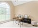 Stylish home office featuring a modern desk, decor, and a large window with natural light at 7406 Cherry Blossom Way, Winston, GA 30187