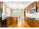 Well-maintained kitchen features hardwood floors, granite countertops, and stainless-steel appliances at 7406 Cherry Blossom Way, Winston, GA 30187