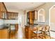 Spacious kitchen features wood cabinets, a breakfast bar, granite countertops, and modern appliances at 7406 Cherry Blossom Way, Winston, GA 30187