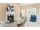 Bright living room features a fireplace, vaulted ceilings, and two large windows at 7406 Cherry Blossom Way, Winston, GA 30187