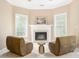 Inviting living room nook featuring a fireplace and two cozy chairs at 7406 Cherry Blossom Way, Winston, GA 30187