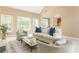 Open living room with vaulted ceiling, large windows, and access to outdoor deck at 7406 Cherry Blossom Way, Winston, GA 30187