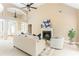 Spacious and cozy living room with a fireplace and plush white carpet and furniture at 7406 Cherry Blossom Way, Winston, GA 30187