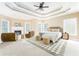 Spacious main bedroom featuring a trey ceiling, fireplace, sitting area, and large windows at 7406 Cherry Blossom Way, Winston, GA 30187