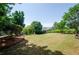 Lush backyard featuring a wide expanse of grass, mature trees, and a well-maintained fence line for added privacy at 9157 Golfview Cir, Covington, GA 30014