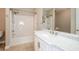 Clean bathroom showcases modern vanity, marble countertop, and shower-tub combination at 9157 Golfview Cir, Covington, GA 30014