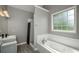 Updated bathroom featuring a tub, a glassed shower and modern vanity at 9157 Golfview Cir, Covington, GA 30014