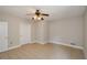 Spacious bedroom offers ample closet space, ceiling fan, and tile flooring at 9157 Golfview Cir, Covington, GA 30014