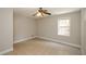 Well-lit bedroom with tile floor, ceiling fan, and one double-hung window at 9157 Golfview Cir, Covington, GA 30014