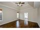 Spacious bedroom features a tray ceiling, hardwood floors, and an attached bathroom at 9157 Golfview Cir, Covington, GA 30014