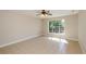 Bright bedroom with large window, ceiling fan, and neutral paint throughout at 9157 Golfview Cir, Covington, GA 30014