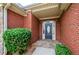 Stylish front entrance featuring a brick facade, stone pathway and manicured landscaping at 9157 Golfview Cir, Covington, GA 30014