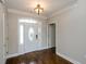 Elegant foyer with hardwood floors, a decorative front door, and neutral paint at 9157 Golfview Cir, Covington, GA 30014