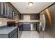Well-lit kitchen offers black appliances, stainless steel refrigerator, and lots of cabinets at 9157 Golfview Cir, Covington, GA 30014