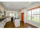 Well-lit kitchen with white cabinets, center island, granite countertops, and stainless steel appliances at 9157 Golfview Cir, Covington, GA 30014