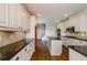 Spacious kitchen with white cabinets, granite countertops, center island, and hardwood floors at 9157 Golfview Cir, Covington, GA 30014