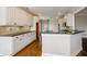 Bright kitchen with white cabinets, granite countertops, stainless steel appliances, and hardwood floors at 9157 Golfview Cir, Covington, GA 30014