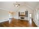 Open living room with hardwood floors, fireplace, built-ins, and natural light at 9157 Golfview Cir, Covington, GA 30014