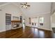 Bright living room with hardwood floors, a fireplace, built-in bookshelves, and vaulted ceilings at 9157 Golfview Cir, Covington, GA 30014