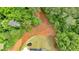 A bird's-eye view reveals a modern home surrounded by greenery and open space, creating a private setting at 157 Palisade Ne Dr, Rydal, GA 30171