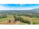 An aerial shot captures a modern home in a serene, expansive setting with mountain views in the background at 157 Palisade Ne Dr, Rydal, GA 30171