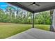 This is a green backyard with natural landscaping and a covered patio at 157 Palisade Ne Dr, Rydal, GA 30171