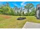 This backyard features green grass, mulch, and landscaping at 157 Palisade Ne Dr, Rydal, GA 30171