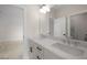 Modern bathroom with dual sinks, white cabinetry, and a large mirror reflecting a view into another room at 157 Palisade Ne Dr, Rydal, GA 30171