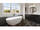 Modern bathroom with soaking tub, dual vanity, and large window at 157 Palisade Ne Dr, Rydal, GA 30171