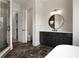 Bathroom featuring a dark vanity with a round mirror and a view into the water closet at 157 Palisade Ne Dr, Rydal, GA 30171