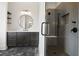 Beautiful bathroom featuring a sleek vanity, a round mirror, and a frameless glass shower at 157 Palisade Ne Dr, Rydal, GA 30171