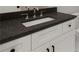 Modern bathroom featuring granite countertops, white cabinets, and black hardware at 157 Palisade Ne Dr, Rydal, GA 30171