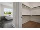Bright bathroom boasts a soaking tub next to a window and a view into the walk-in closet at 157 Palisade Ne Dr, Rydal, GA 30171