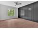 Spacious bedroom with natural light, ceiling fan, and gray accent wall at 157 Palisade Ne Dr, Rydal, GA 30171