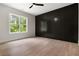 Bedroom with hardwood floor, feature wall, and large window at 157 Palisade Ne Dr, Rydal, GA 30171