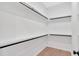 Walk-in closet with black rods and white shelves at 157 Palisade Ne Dr, Rydal, GA 30171