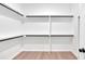 Walk-in closet with built-in storage shelves and rods at 157 Palisade Ne Dr, Rydal, GA 30171