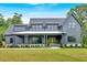 Stunning gray modern farmhouse with a covered porch, double doors, and professionally landscaped front yard at 157 Palisade Ne Dr, Rydal, GA 30171