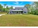 Gray modern farmhouse with covered porch and professionally landscaped yard at 157 Palisade Ne Dr, Rydal, GA 30171