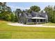 Beautiful two-story gray home featuring a two-car garage and a meticulously landscaped front yard at 157 Palisade Ne Dr, Rydal, GA 30171