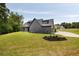 Side exterior view of a modern two-story gray home and lush backyard at 157 Palisade Ne Dr, Rydal, GA 30171
