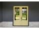 Elegant yellow double front doors framed by stone and dark siding at 157 Palisade Ne Dr, Rydal, GA 30171